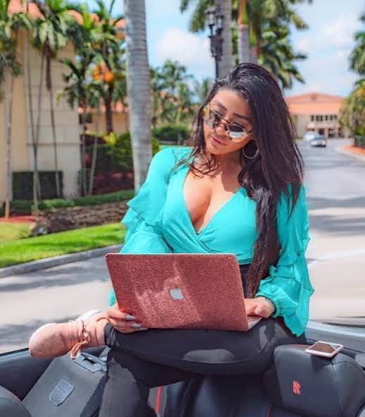 Ariella working outdoors with her laptop